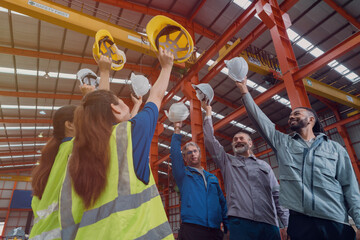 A group of engineers and staff members are discussing their work while working in a metal sheet and...