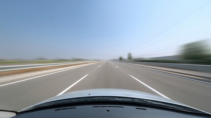 Fototapeta premium Dynamic Perspective of an Open Road with Speed Blur Effect Captured from a Moving Vehicle, Showcasing a Clear Sky and Scenic Landscape