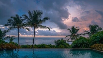 Fototapeta premium Palm trees by the pool at sunset with a tropical beach and ocean view