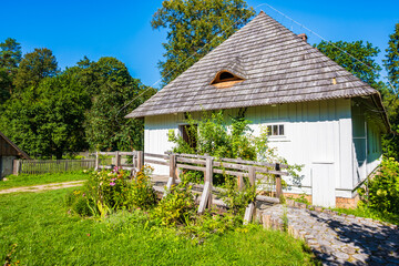 Rustic old wooden house on green meadow, Roztocze National Park, Poland