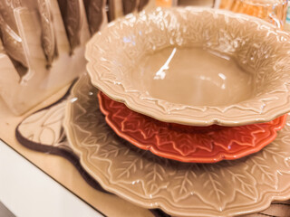 Stack of elegant ceramic plates with leaf design in prague shop halloween
