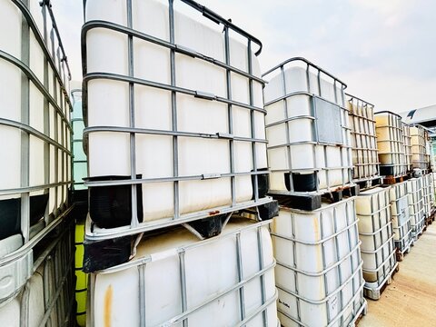 Stacked industrial bulk containers offer a reusable packaging solution for the transportation and storage of liquids and granulated substances ensuring safe and eco-friendly logistical operations