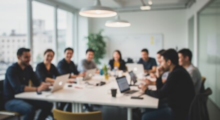 Group of people sitting around a table in a bright modern office.