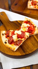 Pizza slice with pepperoni, tomato, and cheese