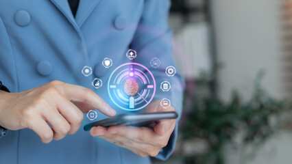 Business hand using smartphone with fingerprint biometric authentication hologram, concept of cybersecurity, secure login, digital identity, mobile banking, privacy protection, and data security.