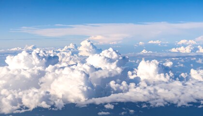 High-altitude view of fluffy white clouds against a vibrant blue sky
