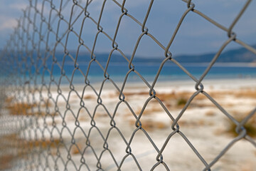The beach view seen beyond the wire fence. No entry into Lake Salda.