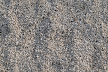 Close-up image of white, stone-like particles on the shore of Lake Salda in Turkey.