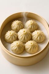 Fototapeta premium Steaming hot dumplings in a bamboo steamer basket