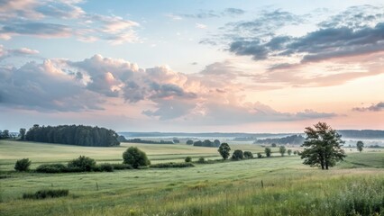 Scenic sunrise over lush green fields and rolling hills