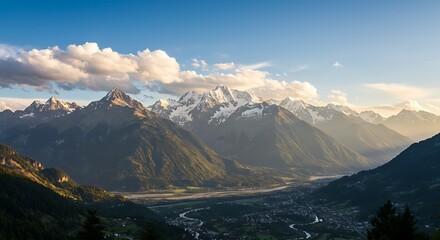 Majestic snow-capped mountains at sunrise with a valley below.