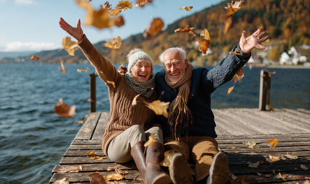 joyful senior couple is throwing up colorful autumn leaves