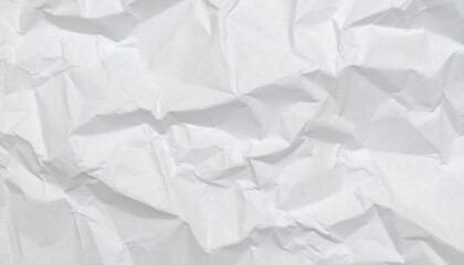 A close-up shot of a crumpled white paper surface. 
