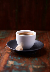 Cup of coffee on rustic wooden background. Soft focus. Copy space	