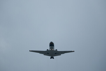 Airplane in the cloudy sky. Private plane in flight, Business jet in the sky.