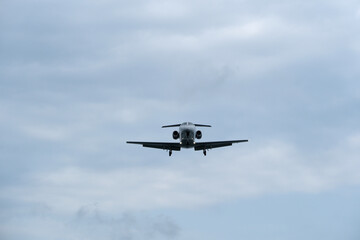 Airplane in the cloudy sky. Private plane in flight, Business jet in the sky.