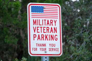 Extreme closeup of sign in a parking lot reserving a parking spot for Military Veterans