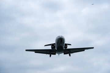Airplane in the cloudy sky. Private plane in flight, Business jet in the sky.