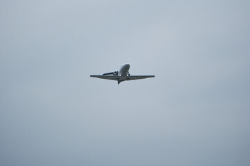 Airplane in the cloudy sky. Private plane in flight, Business jet in the sky.