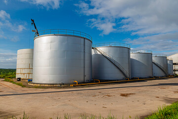 Crude Oil Industry, White Storage Fuel Gas Container Tanks in Petroleum Refinery Industrial Factory area against