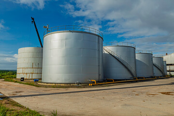 Crude Oil Industry, White Storage Fuel Gas Container Tanks in Petroleum Refinery Industrial Factory area against