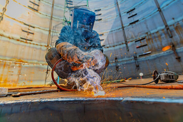 Welding male worker metal is part of machinery plate roof tank beam construction