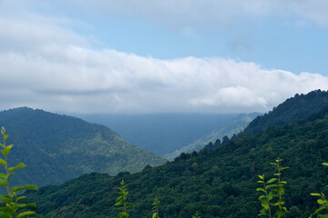Mountains, clouds and blue sky. Lush Georgian hills, soft clouds and bright blue sky.