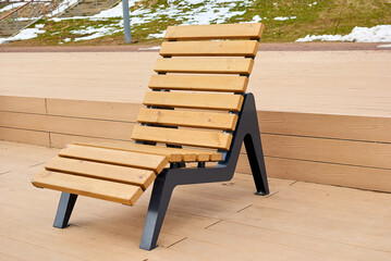 A wooden veranda with two deck chairs. The chairs are set up so that you can enjoy the view of the...
