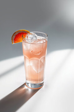 Refreshing cocktail served in tall glass with ice and citrus garnish on a sunny day