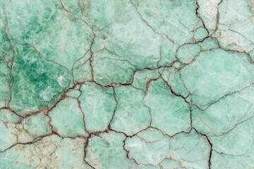 Fototapeta premium A close-up view of a teal-toned stone surface with intricate cracks