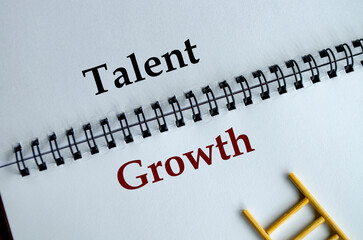 Talent Growth, Notepad displaying the phrase Talent Growth written neatly in black text with a...