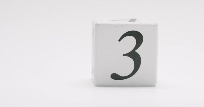 Minimalistic image of a wooden block displaying the number three, isolated on a white background. Wooden Block With Number Three On White Background