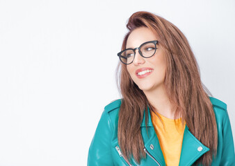 Happy young woman looking to side, wearing green leather jacket, isolated on white background....