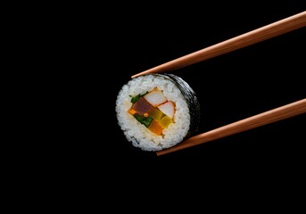 A cinematic shot of picking up a piece of kimbap against a black background