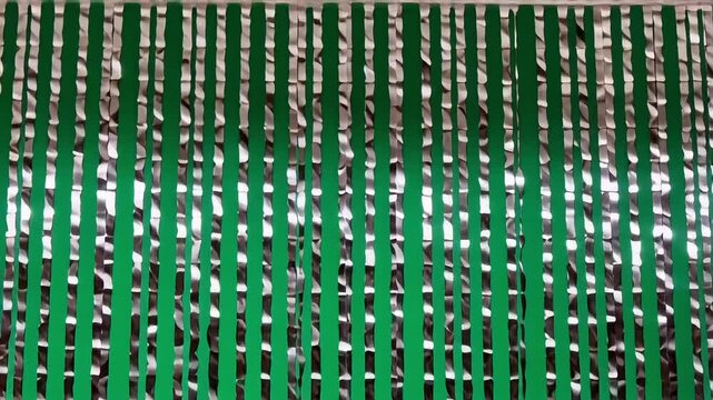 Vertical green stripes create a dynamic, abstract background texture with a metallic sheen.