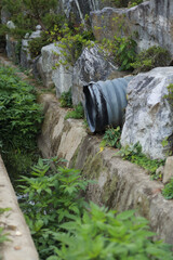 Grass growing luxuriantly under a drain in the countryside