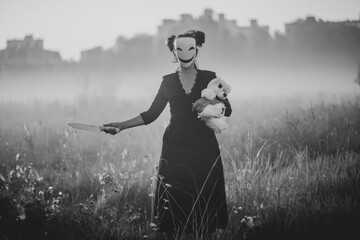 Spooky Halloween scene with mask, teddy bear, and knife