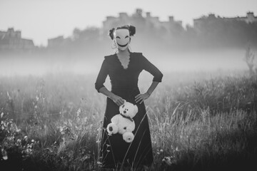 Spooky Halloween scene with mask, teddy bear, and knife