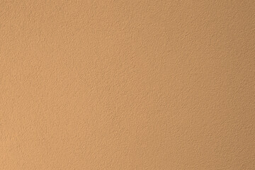 pink peach fuzz beige new modern concrete wall home house building exterior texture - close up banner format background with empty copy space for text. brown coral color texture pattern backdrop.