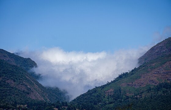 Clouds among green mountains