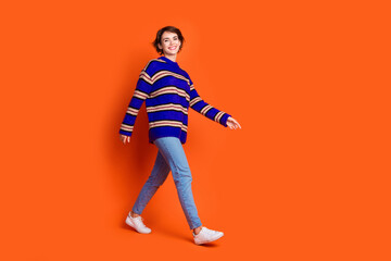 Photo of cute pretty nice woman wear stylish clothes going market empty space isolated on orange...