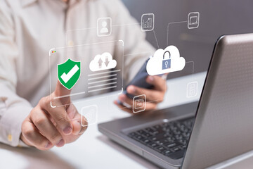 A person interacts with a digital interface showing security icons, indicating a focus on data protection and cloud technology.