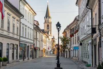 Fototapeta premium Central street of the picturesque town of Kranj with beautiful buildings and church towers, Slovenia.