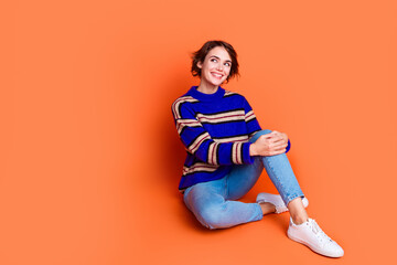 Photo portrait of young brown hair lady in blue striped cute sweater sitting floor daydreaming...