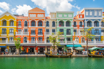 Colorful European style buildings and gondolas along peaceful canal on Phu Quoc island, Vietnam, with cafes, shops and tourists enjoying the vibrant waterfront. Grand world city. Italian architecture © samael334