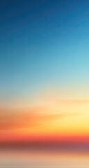 Obraz premium Soft sunset sky blends from warm orange to cool blue