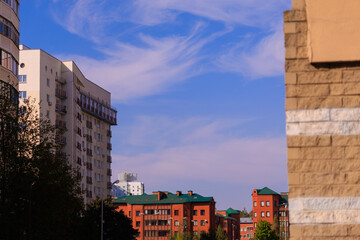 Fototapeta premium Cityscape on a sunny day, modern buildings and houses 