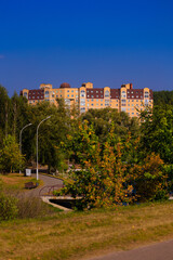 Cityscape on a sunny day, modern buildings and houses 
