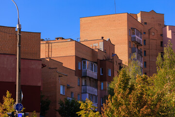 Cityscape on a sunny day, modern buildings and houses 