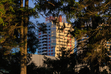 Cityscape on a sunny evening, modern buildings and houses 